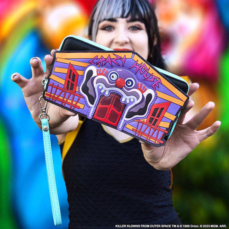 Woman holding out the Killer Klowns from Outer Space wallet toward the camera